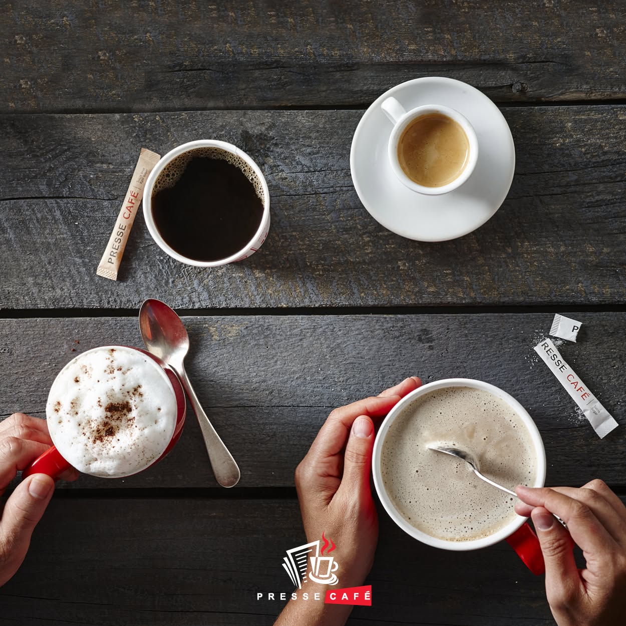 A flatlay of Presse Café espresso, filter coffee and cappuccino cups on a rustic wooden table